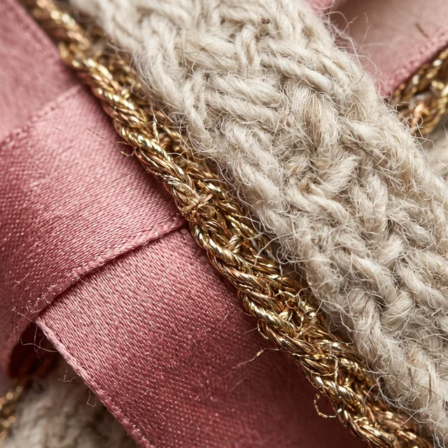 Nano Banana 2.1: Extreme macro close-up of woven textile samples: rose silk, undyed wool and gold thread cr